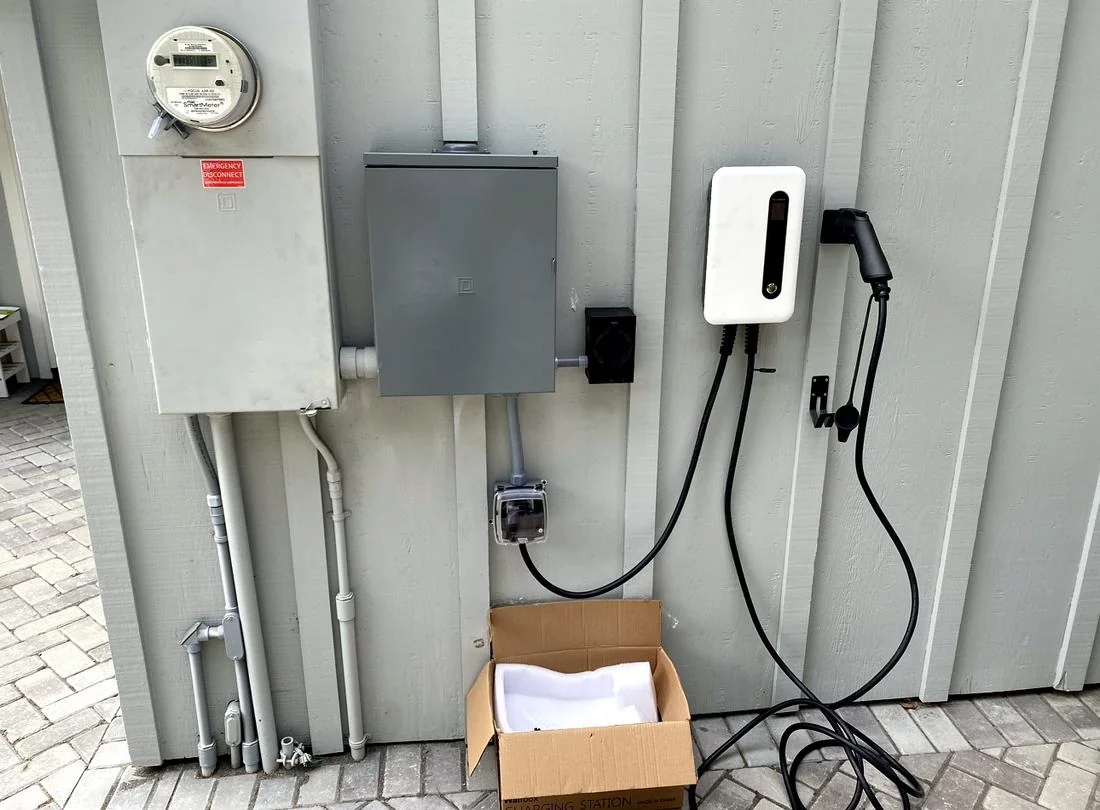 EV charger installed alongside the electrical panel by Spark Electrical Solutions